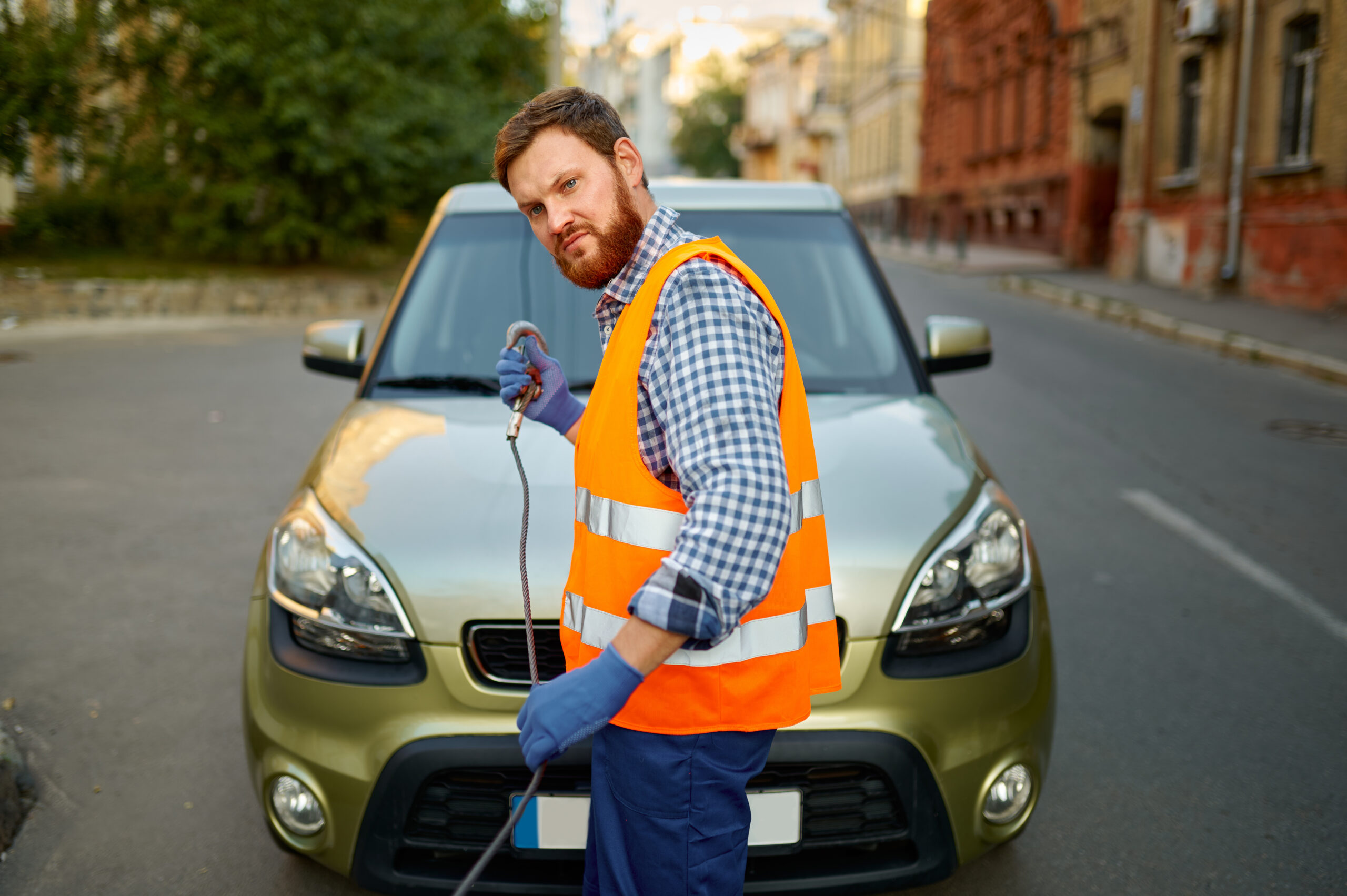 worker preparing vehicle for loading onto car transporter