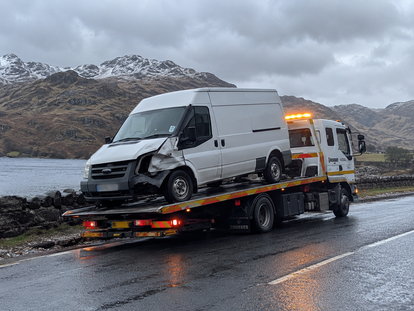 Van recovery East Calder – white commercial van transported on a flatbed recovery truck