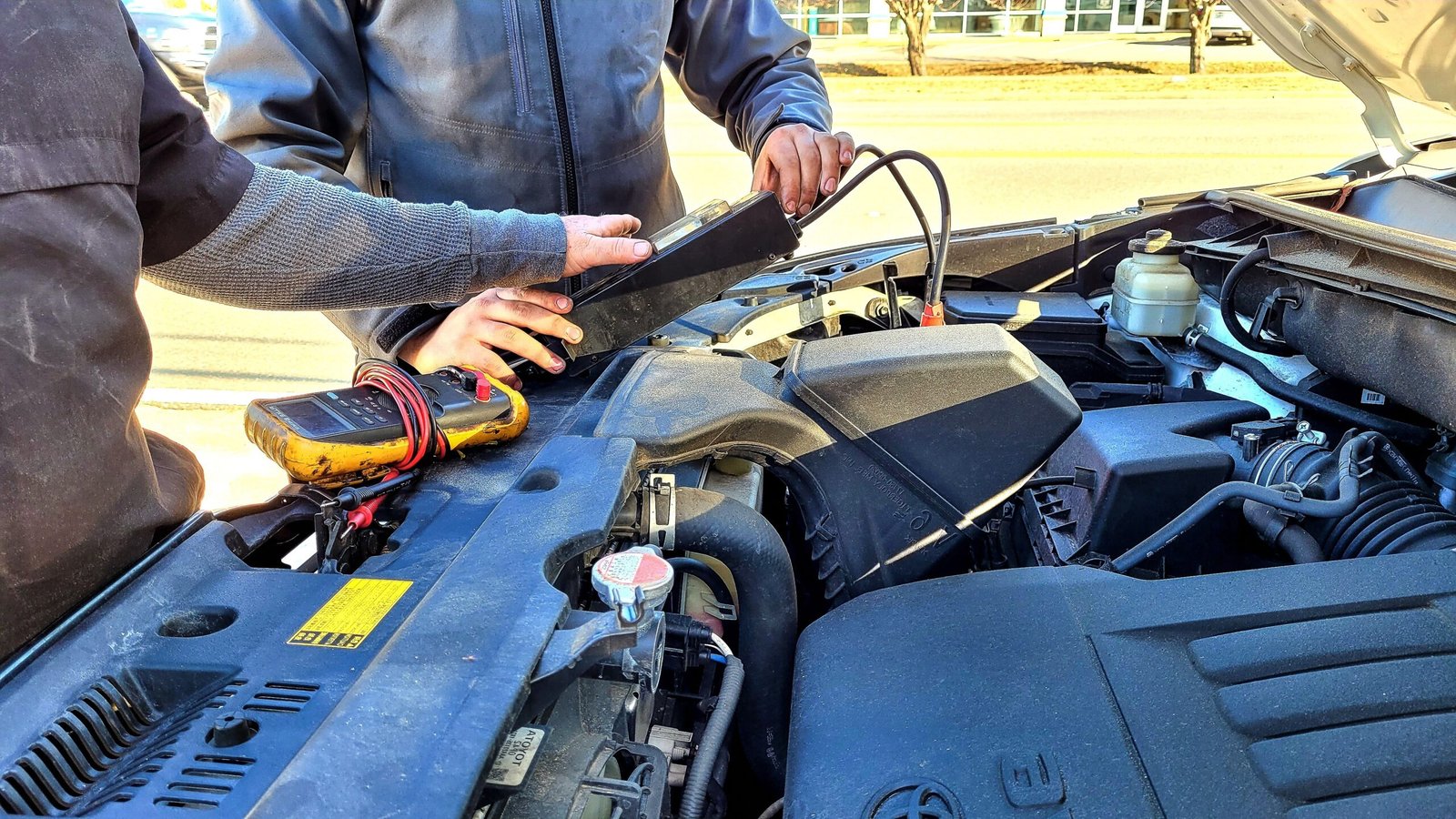 Roadside assistance Armadale – mechanic checking a car engine under an open bonnet