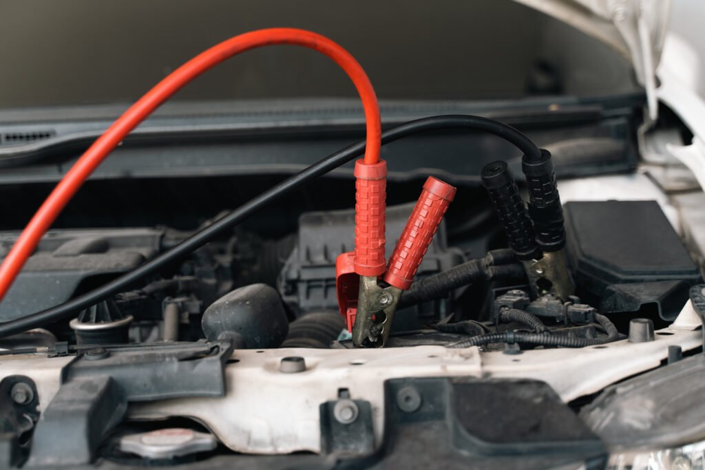 Roadside assistance Bo'ness – mechanic jump starting a car with a flat battery