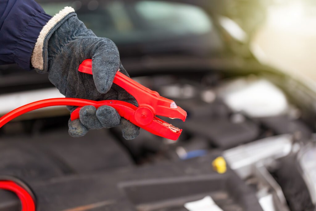 Roadside assistance Broxburn – jump-starting a car battery using red jumper cables
