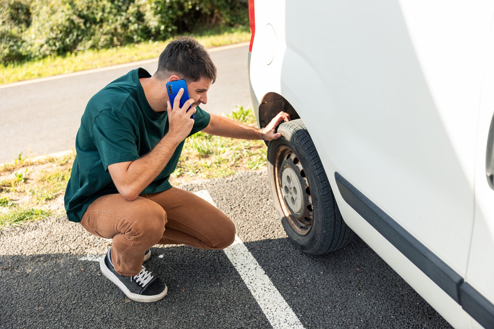 Driver calling for roadside assistance with a flat tyre – car recovery West Lothian