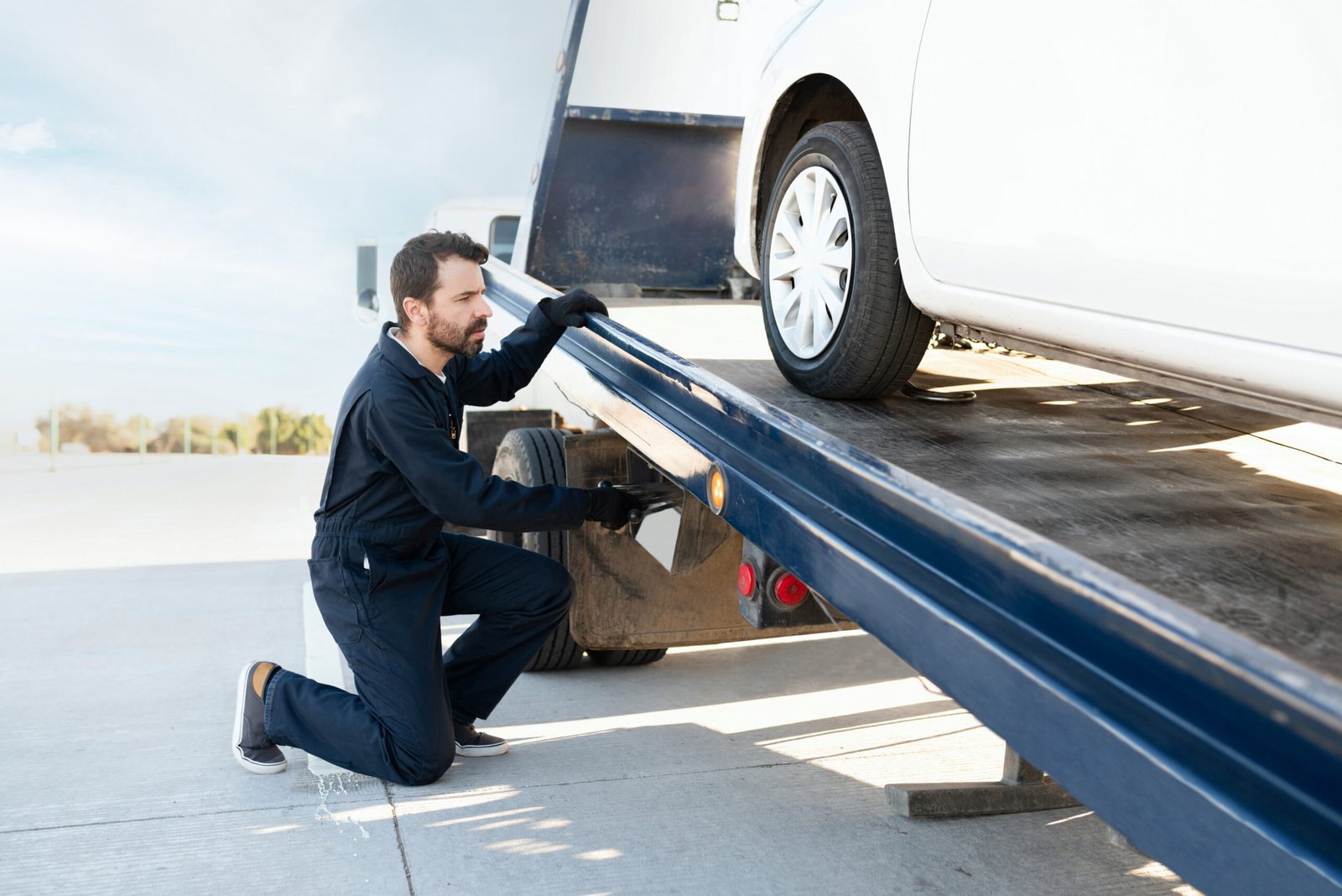 Car recovery Livingston – operator preparing a flatbed recovery truck
