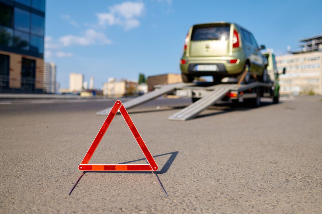 Breakdown recovery Armadale – warning triangle on the road with a vehicle on a recovery truck