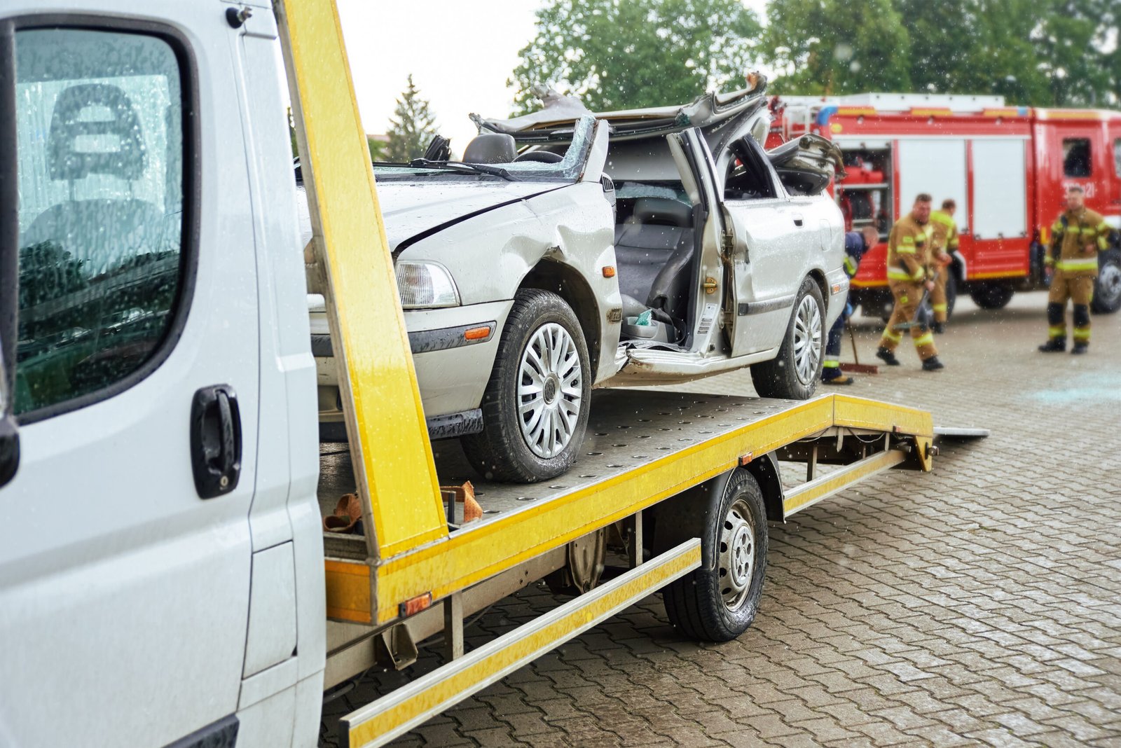Accident recovery Bathgate – damaged car being transported on a flatbed recovery truck