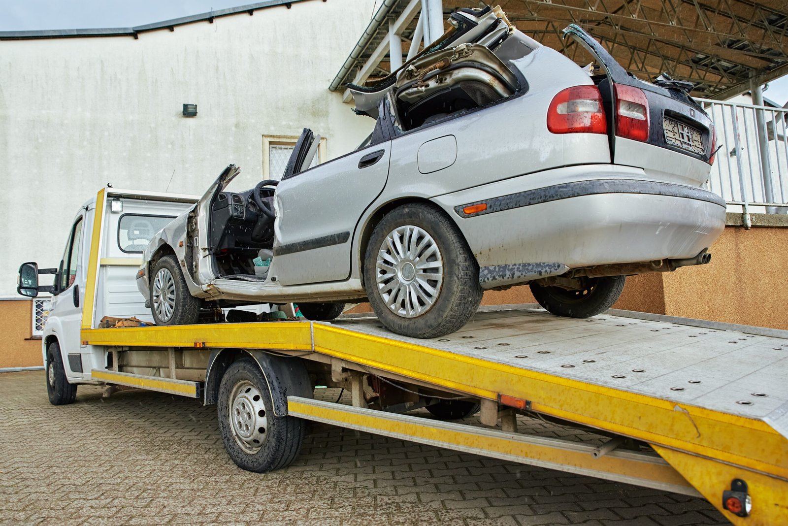 Accident recovery Whitburn – damaged silver car on a flatbed recovery truck